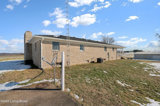 view of side of property with cooling unit and a lawn