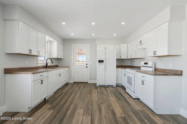 kitchen featuring sink, white appliances, white cabinetry, and wooden counters