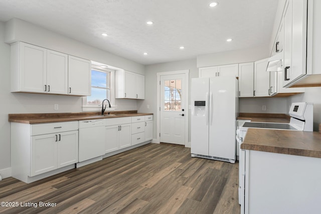 kitchen with sink, white cabinetry, white appliances, and dark hardwood / wood-style flooring