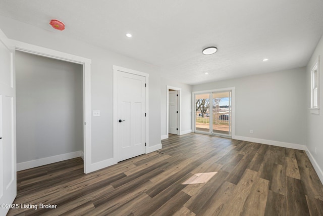 interior space featuring dark wood-type flooring and access to exterior