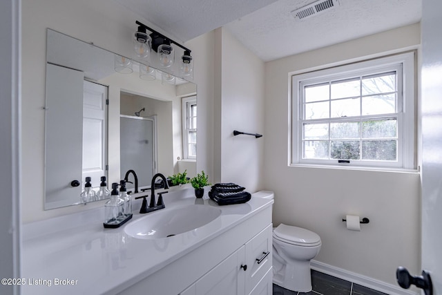 bathroom featuring toilet, an enclosed shower, a textured ceiling, tile patterned flooring, and vanity