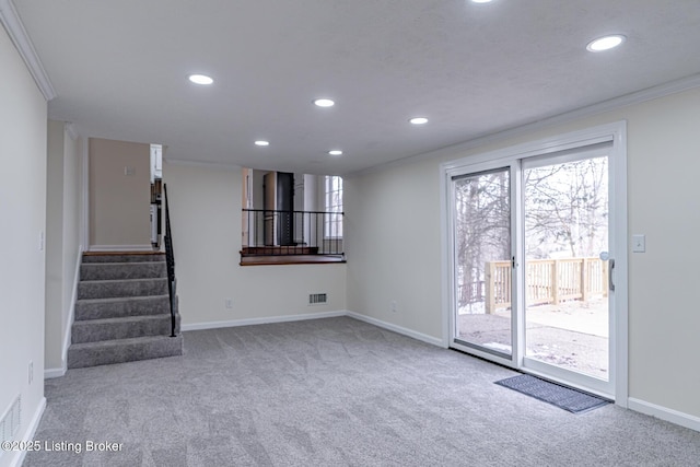 unfurnished living room with carpet and ornamental molding