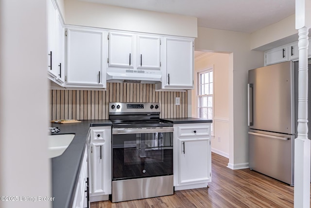 kitchen featuring decorative backsplash, white cabinetry, stainless steel appliances, and light wood-type flooring