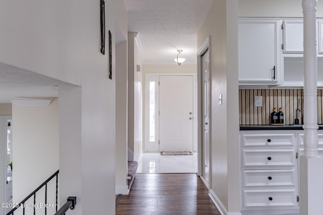 hallway featuring crown molding and dark hardwood / wood-style floors