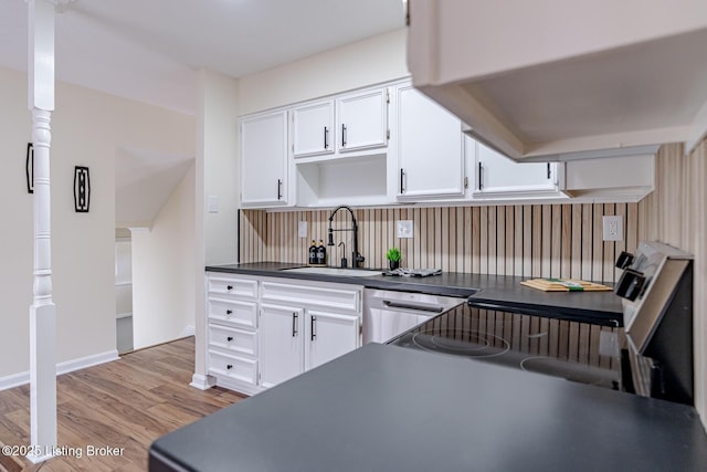 kitchen with sink, stainless steel dishwasher, white cabinetry, and light hardwood / wood-style floors