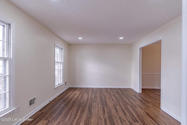 unfurnished room with dark hardwood / wood-style floors