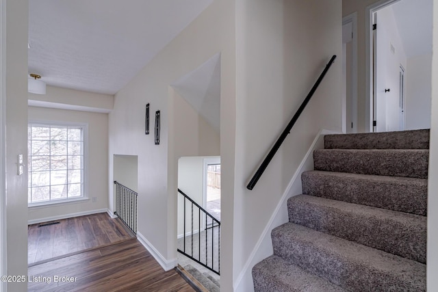 stairs featuring hardwood / wood-style flooring