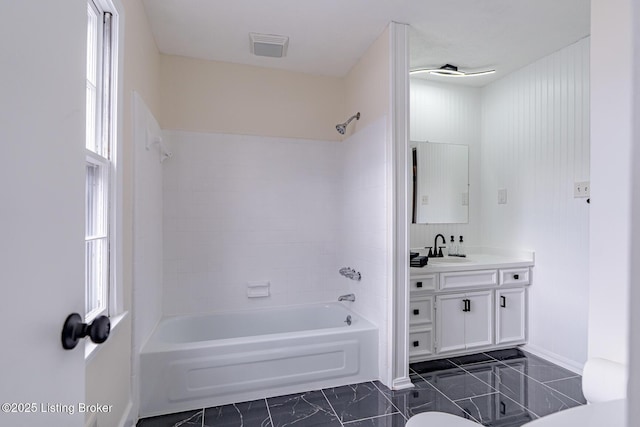 full bathroom with toilet, vanity, and tiled shower / bath