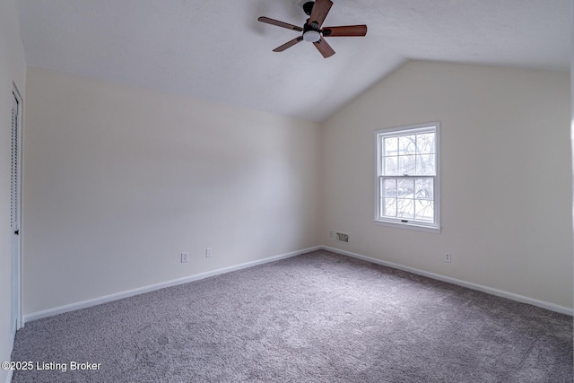 carpeted spare room featuring ceiling fan and lofted ceiling