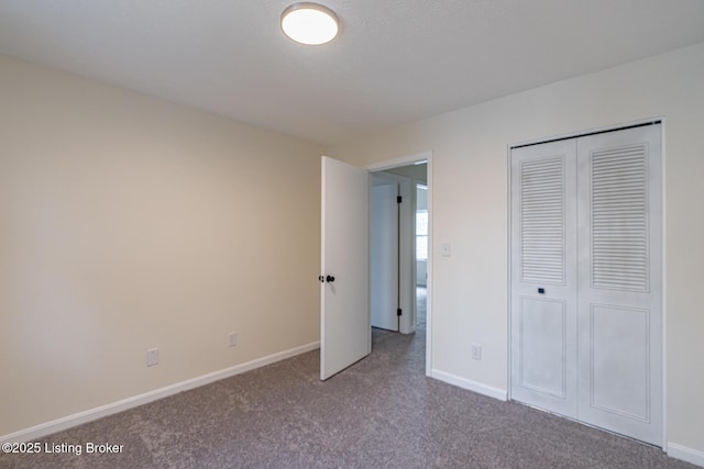 unfurnished bedroom with carpet floors and a closet