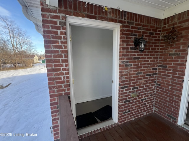 view of snow covered property entrance