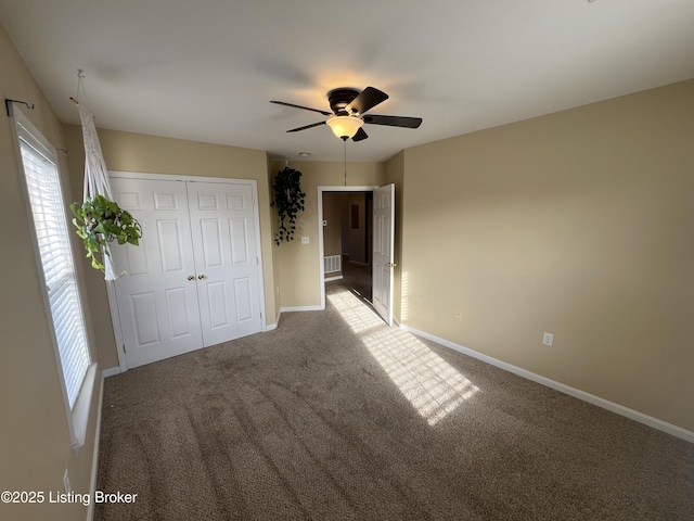 unfurnished bedroom with light colored carpet, a closet, and ceiling fan