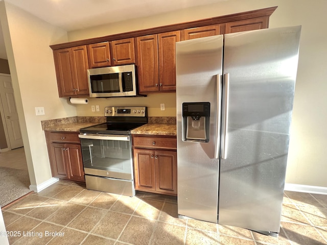 kitchen featuring light carpet and stainless steel appliances