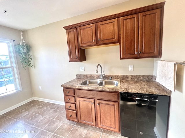 kitchen with sink, dishwasher, a healthy amount of sunlight, and light tile patterned flooring