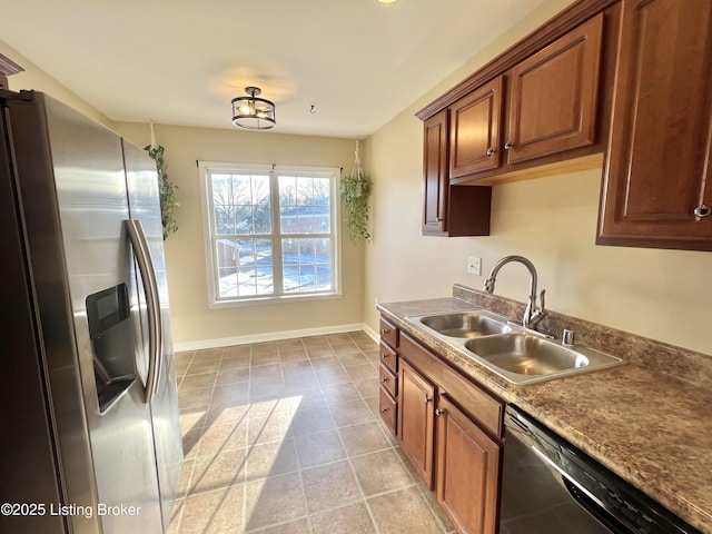 kitchen with sink, stainless steel appliances, and light tile patterned floors