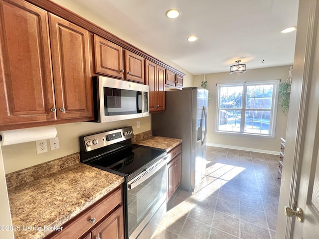 kitchen with stainless steel appliances and light stone counters