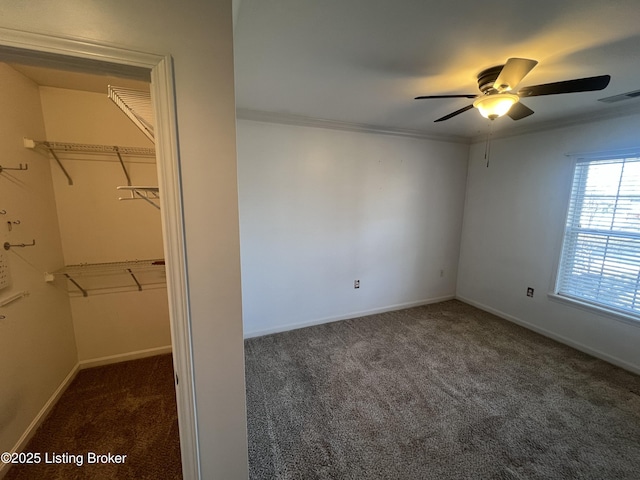 carpeted spare room with ceiling fan and crown molding