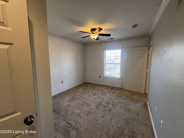 unfurnished bedroom with crown molding, light colored carpet, and ceiling fan