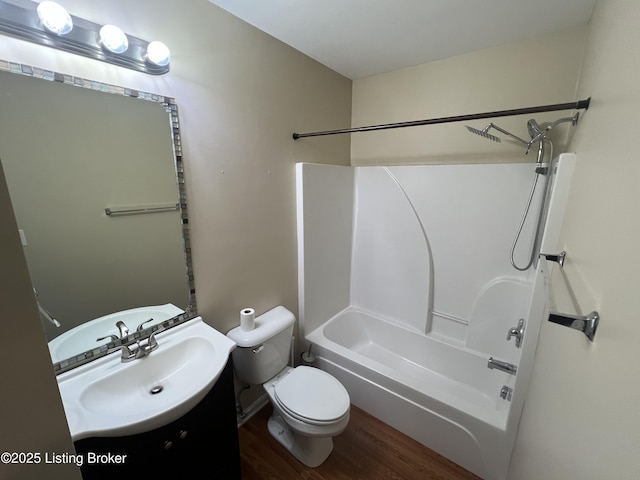 full bathroom with vanity, toilet, hardwood / wood-style flooring, and shower / bathing tub combination