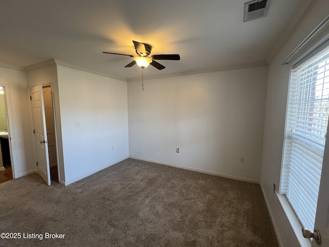 carpeted spare room with ceiling fan and ornamental molding