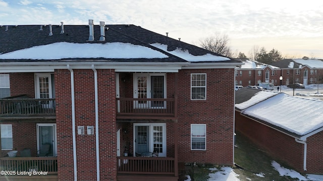 view of snow covered rear of property