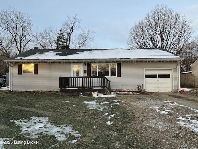 single story home with a garage, a deck, and a yard