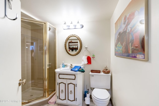 bathroom with an enclosed shower, vanity, and toilet