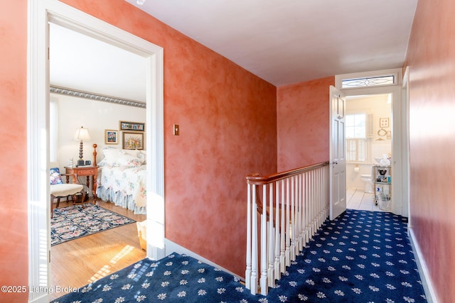 hallway with hardwood / wood-style floors