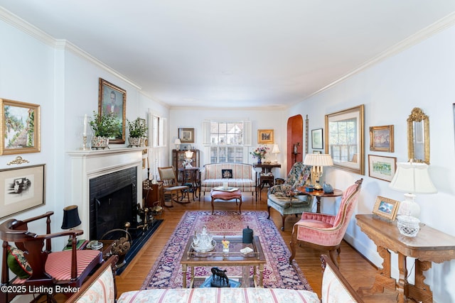 living room with ornamental molding and light hardwood / wood-style floors