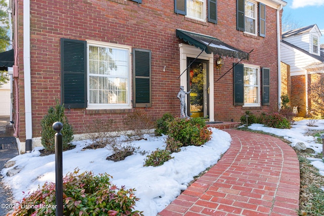 view of snow covered property entrance