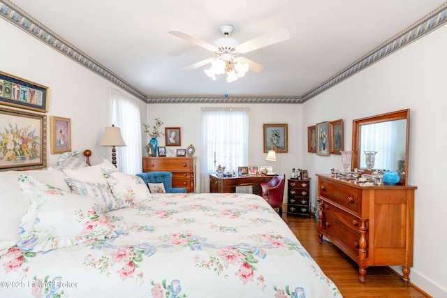 bedroom with dark hardwood / wood-style flooring and ceiling fan