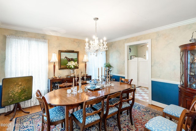 dining area with a wealth of natural light, hardwood / wood-style floors, and crown molding