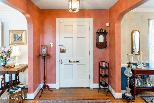 foyer featuring hardwood / wood-style floors and ornamental molding