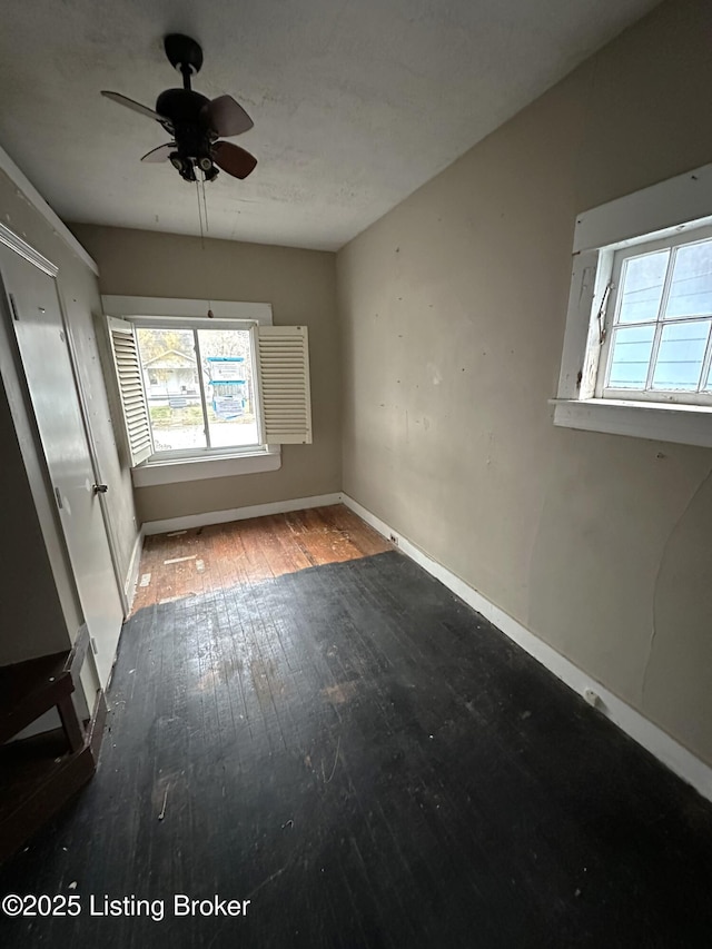 unfurnished room with ceiling fan and wood-type flooring