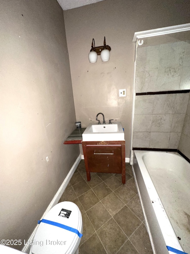 bathroom featuring vanity, toilet, a bath, and tile patterned floors