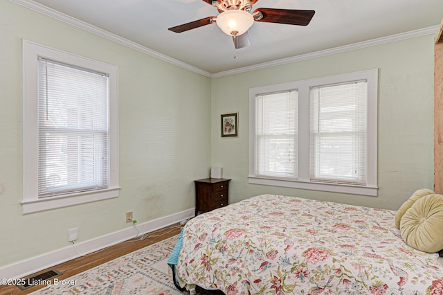 bedroom featuring ceiling fan, wood-type flooring, and crown molding