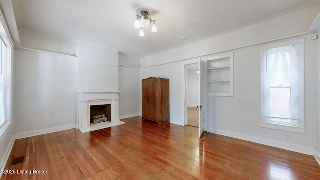 unfurnished living room featuring wood-type flooring