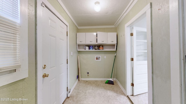 laundry room featuring hookup for a washing machine, ornamental molding, cabinets, and a textured ceiling