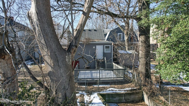 back of house with a deck