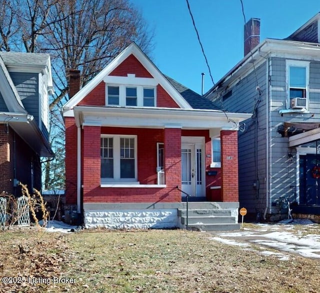 view of front of house with cooling unit and a porch