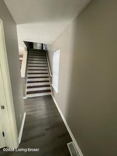 stairs featuring hardwood / wood-style flooring