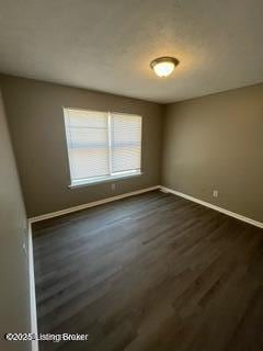 empty room featuring dark hardwood / wood-style floors