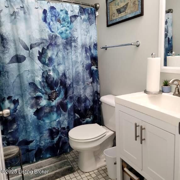 bathroom featuring curtained shower, toilet, tile patterned flooring, and vanity