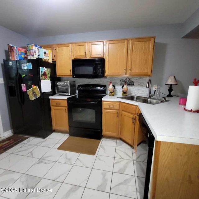 kitchen featuring black appliances, decorative backsplash, and sink