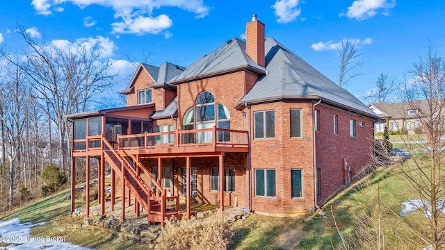 rear view of house with a sunroom and a wooden deck