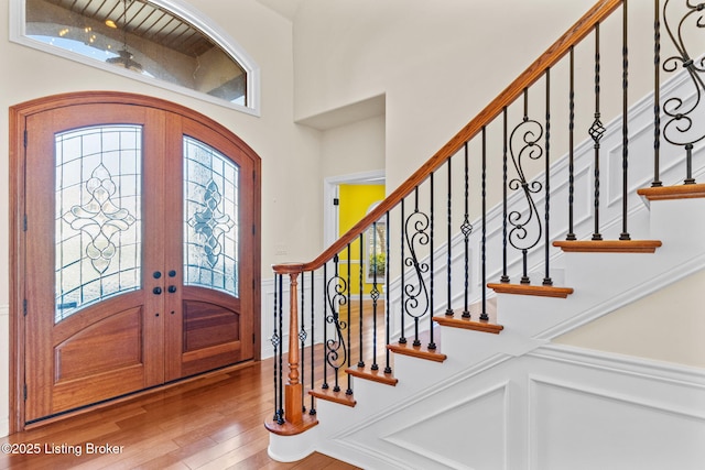 foyer featuring hardwood / wood-style floors and french doors