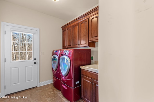 laundry area with cabinets, separate washer and dryer, and sink