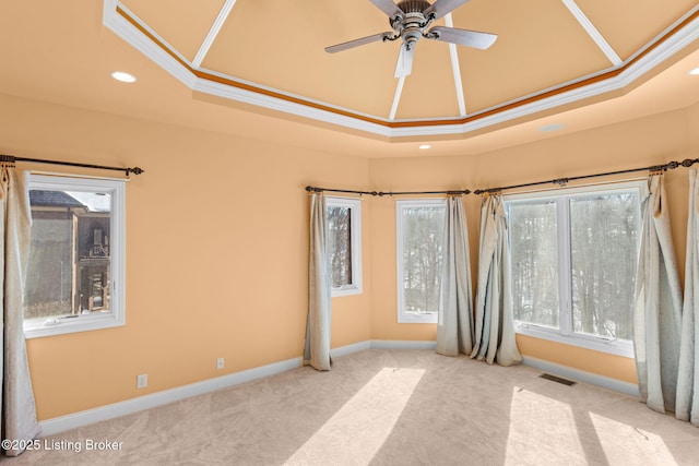 carpeted empty room featuring ceiling fan, a tray ceiling, and crown molding