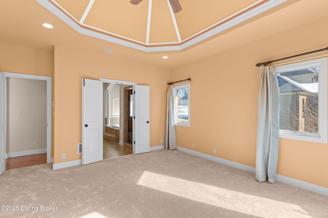 unfurnished bedroom featuring crown molding, light carpet, and ensuite bath