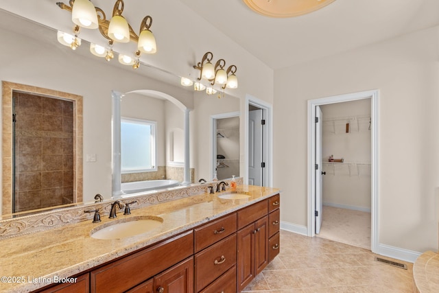 bathroom featuring independent shower and bath, tile patterned floors, and vanity